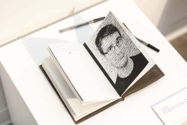 Inside pages of journal with a photo of a face with text written across it.