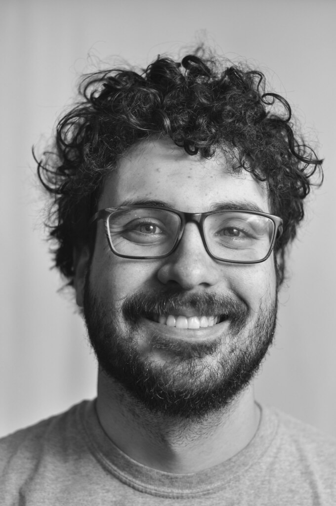 A headshot of a person smiling