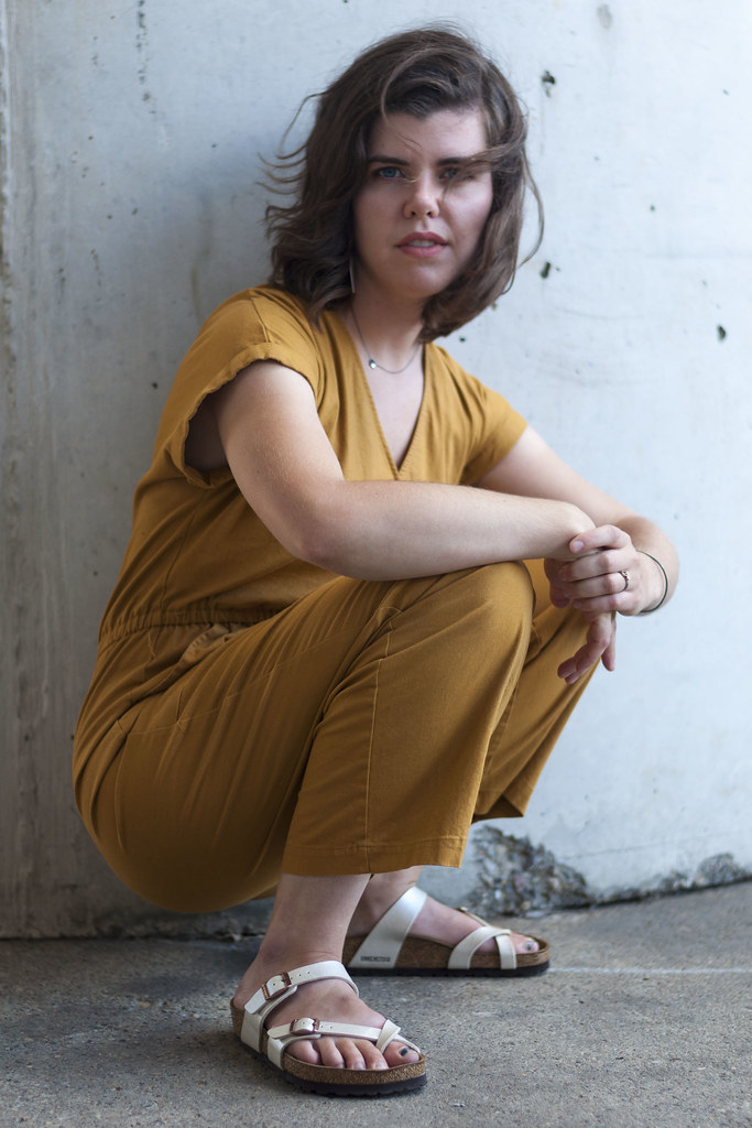 A person in yellow crouching.