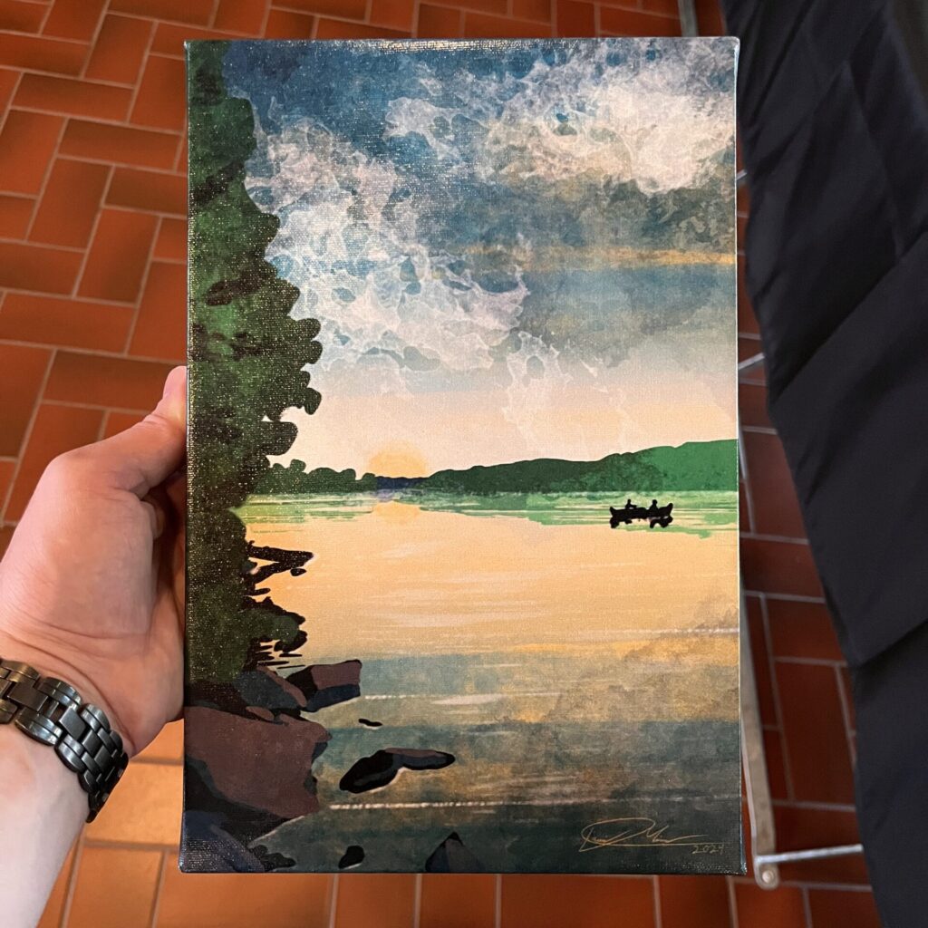 A small canvas print of a sunset illustration.