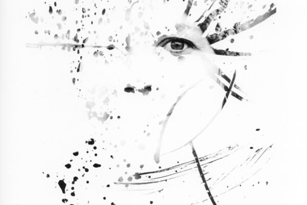 A portrait of a person where most of the image is obscured in white except where splattered liquid has revealed the image.